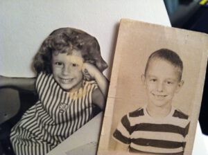 Alice at 7 with a photo of her biological dad at the same age.