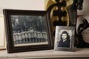 A photo of Mike's mother in front of some art from Africa.
