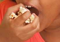 Little Girl Eats Popcorn
