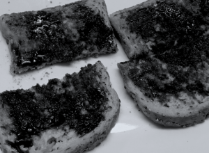 Pieces of toast with Marmite spread over them.